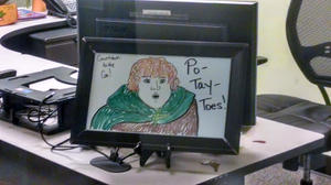 Front desk art drawn by office manager at Emberex in colored whiteboard pens on small whiteboard. Pictured is Samewise Gamgee from Lord of the Rings emphatically pronouncing 'Po-Tay-Toes!'